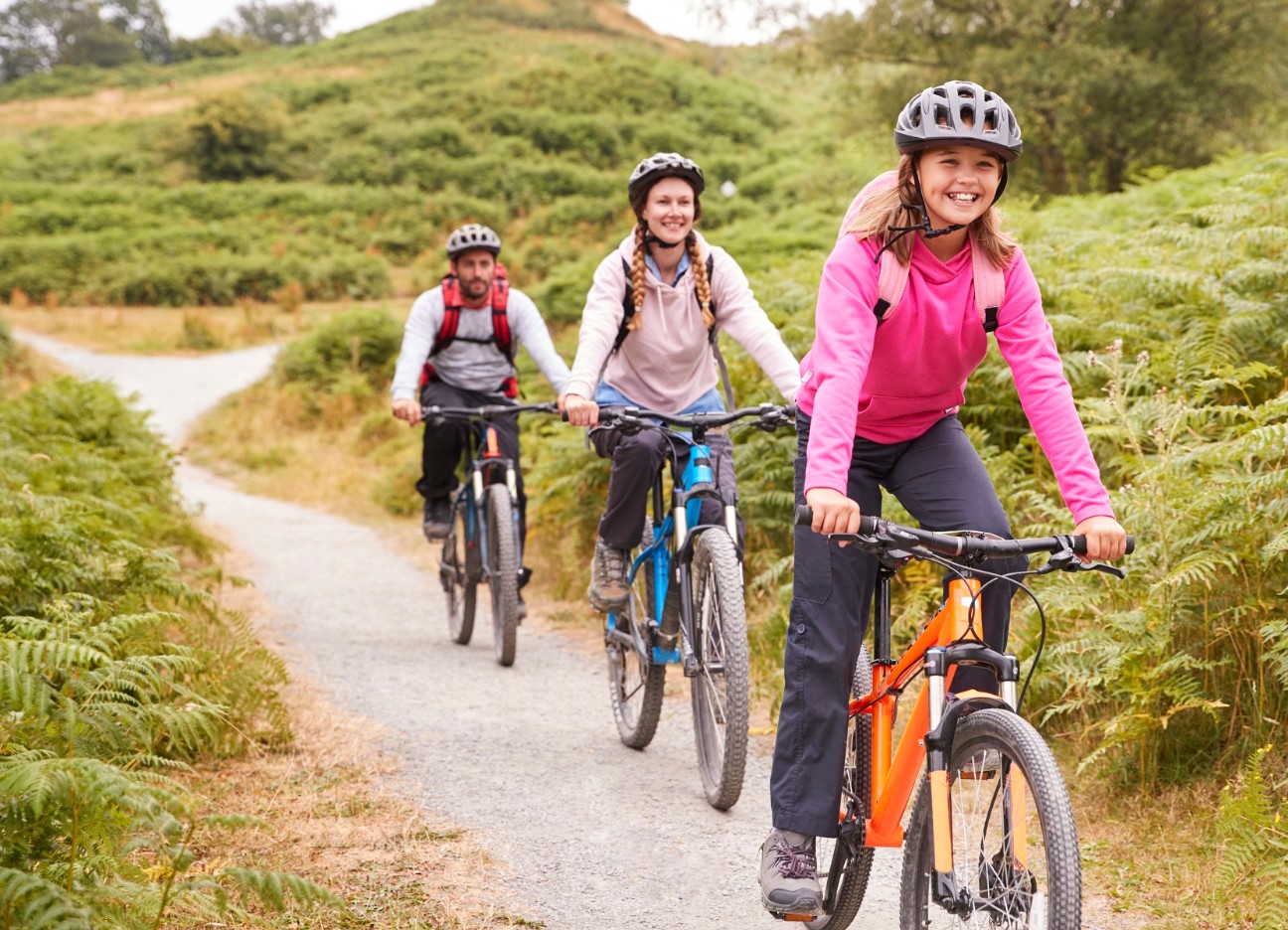 Mädchen fährt Mountain-Bike mit ihren Eltern